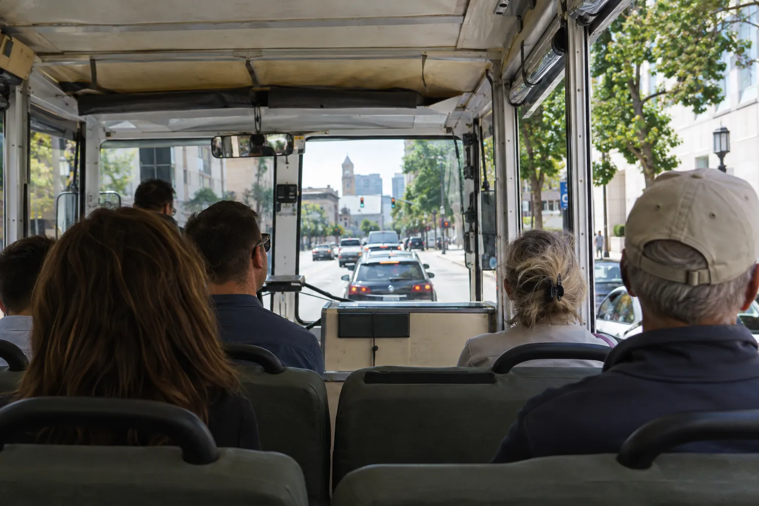 Passengers facing forward during the city-street portion of an amphibious sightseeing tour.