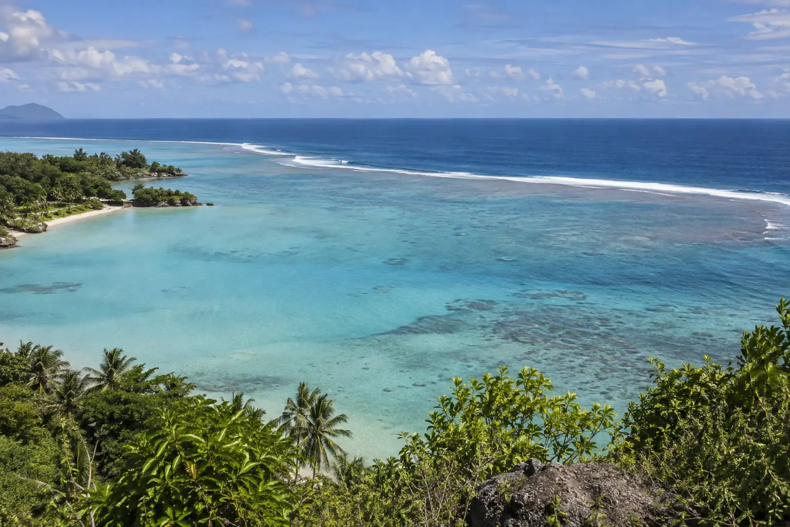 A reef separating protected island lagoon water from the deeper ocean beyond.